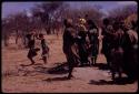 Group of women dancing, with little girls dancing behind them