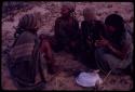 Women playing dandiri, including N/kxabe (daughter of /Oβa) with her foot on the stick, Tomku, Dadum, and ǂKxoba