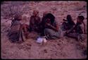 Women playing dandiri, including N/kxabe (daughter of /Oβa), Tomku, Dadum, and ǂKxoba, with a group of children sitting behind them