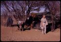 Lorna Marshall standing in front of a tent with a table next to it in the expedition camp