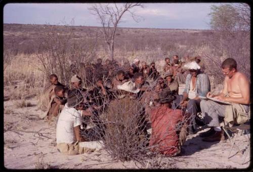 Group of men singing, with Nicholas England recording them, Wilhelm Camm sitting with them