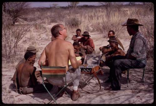 Group of men singing, with Nicholas England recording them, Wilhelm Camm sitting with them