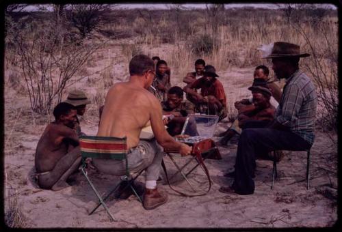 Group of men singing, with Nicholas England recording them, Wilhelm Camm sitting with them