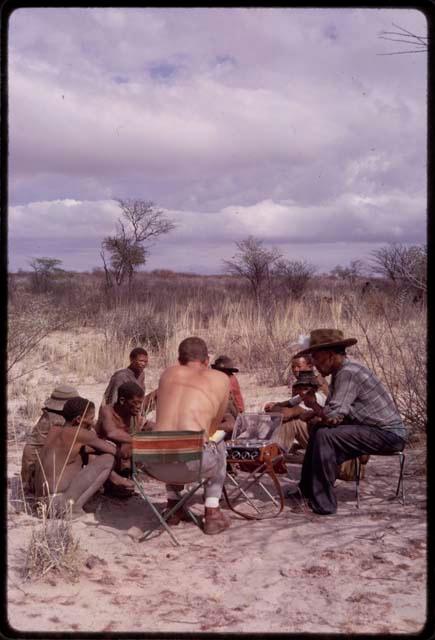 Group of men singing, with Nicholas England recording them, Wilhelm Camm sitting with them