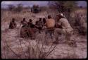 Group of men singing, with Nicholas England recording them, Wilhelm Camm sitting with them, Wulf Haacke photographing them