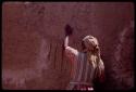 Woman plastering the exterior wall of a new house with mud and dung, in the compound of Boy Moapane, brother of the Kgalagari chief