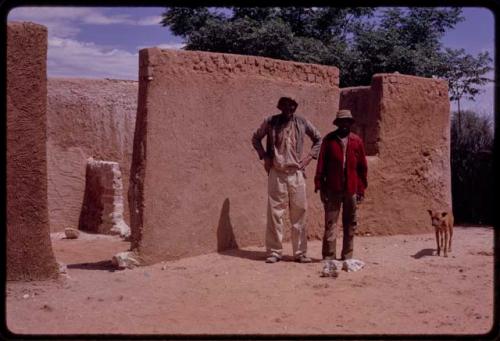 Two builders standing in front of a new house in the compound of Boy Moapane, brother of the Kgalagari chief