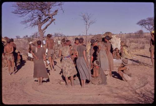 Women getting up to leave the singing circle at the end of a night dance and beginning of a social dance