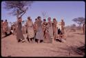 Women getting up to leave the singing circle at the end of a night dance and beginning of a social dance