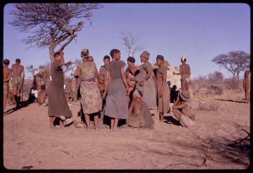 Women getting up to leave the singing circle at the end of a night dance and beginning of a social dance