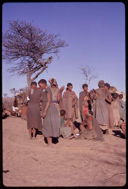 Women getting up to leave the singing circle at the end of a night dance and beginning of a social dance