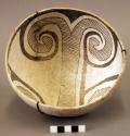 Bowl, black on white curvilinear design, resembles Mimbres, wire suspension sys
