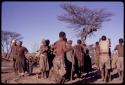 Group of people performing a social dance, including /Gaishay, /Xoxa, and N//aba