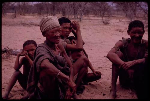 Sãõ?//e sitting with a group of people, listening to a sound recording of a dance