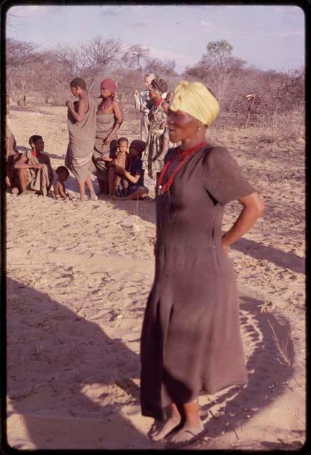 N//aba dancing in a dance circle at a social dance, with a group of women standing and sitting in the background