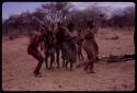 Group of people performing the Eland Dance, including !Ani, ≠Kxoba, !Kxam and three other men