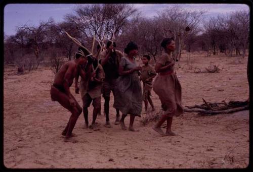 Group of people performing the Eland Dance, including !Ani, ≠Kxoba, !Kxam and three other men