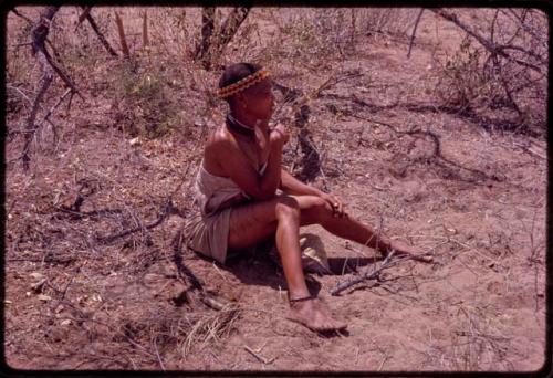 Woman with scarification sitting on the ground