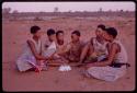 Group of seated women wearing a dress, singing and playing a bow for Nicholas England's sound recording