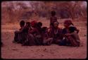 Group of women and children sitting close together early in the morning