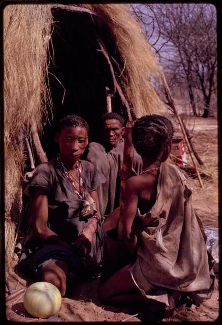 N/aoku wearing a gray dress, ≠Nobe, and a person draped with cloth sitting in front of a skerm