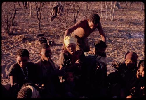 /'O/hei curing one of the women sitting in a circle during a curing dance