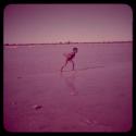 Scenery: Boy running in shallow water in a pan