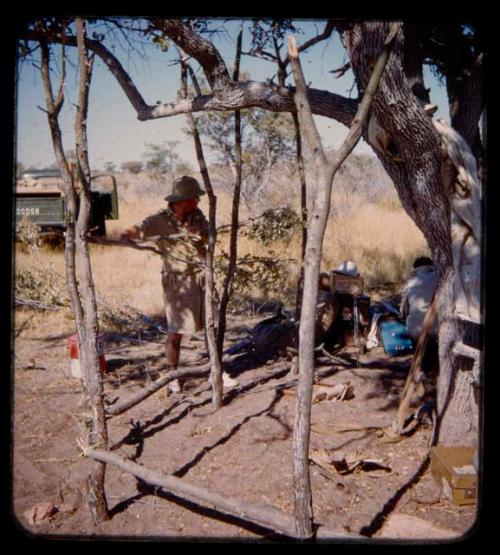 Eric Williams making a shelter at the expedition campsite