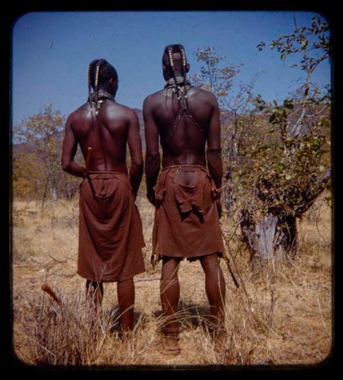 Two young men wearing headdresses for unmarried men