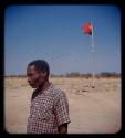 Man standing, with the flag of Portugal in the background