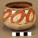 Small ceramic pot, red- and brown-on-white.