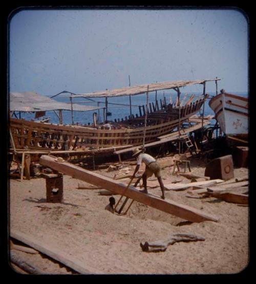 Man sawing a board at Porto Alexandre