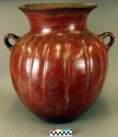 Ceramic jar, two handles, flared lip, incised design, orange slip