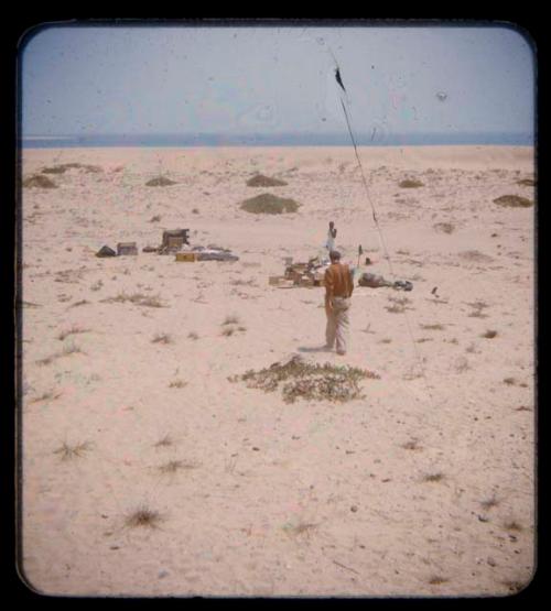 Charles Koch walking at expedition camp below Porto Alexandre