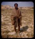 Man standing and holding a stick at the Curoca Valley