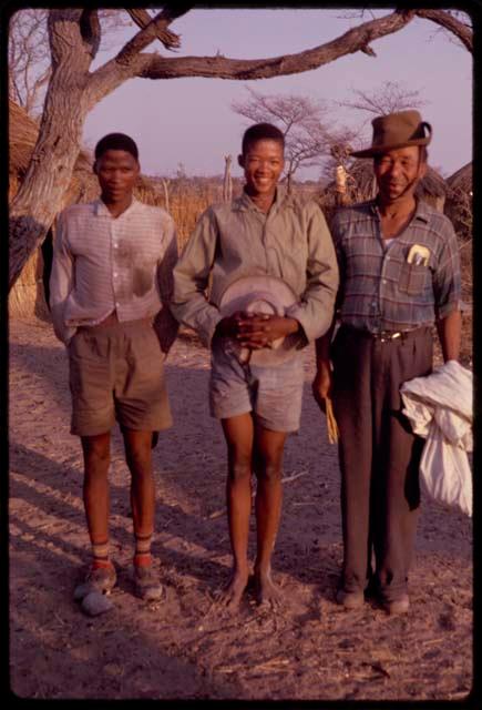 Wilhelm Camm standing beside /Qui (son of "Gao Medicine") and another young man