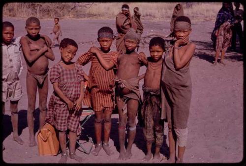 Group of children; Norna, in the plaid dress; to her left in red and white striped dress is //Kushay, wife of Tsamgao; ǂToma's son; daughter of /Qui and /Gasa; behind Norna is /Qui, son of Gau and Khan//a; and the boy in white suit is ǂToma's son, /Gaishay