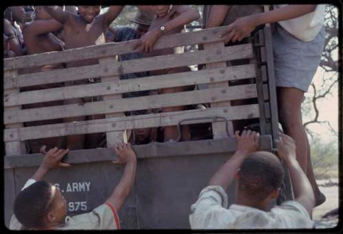 People in the back of an expedition truck, close-up