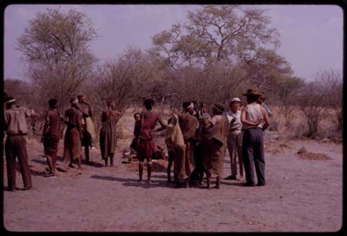 Lorna Marshall and Wilhelm Camm talking with someone, people standing nearby