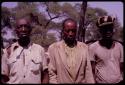 Three men standing who asked to have their pictures taken, close-up