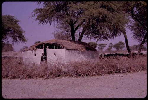 Man standing by the chapel at Kai Kai, seen from a distance