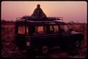 Nicholas England waking up at dawn in his bed atop the expedition Land Rover