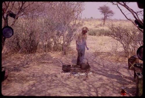 Ngani standing at a cooking fire