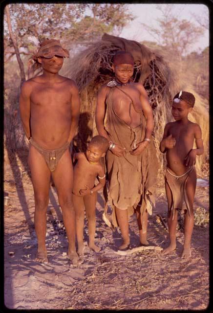 /Ti!kay, headman, and his family standing