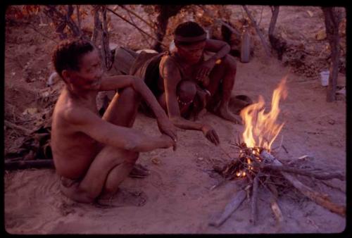 "Old D/ao" and his wife sitting by their fire, close-up