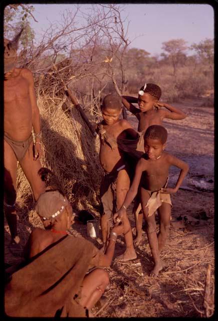 Women handing food to a group of children