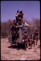 Men on top of expedition Land Rover to carry dead ostrich down