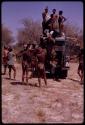 Men on top of expedition Land Rover to carry dead ostrich down