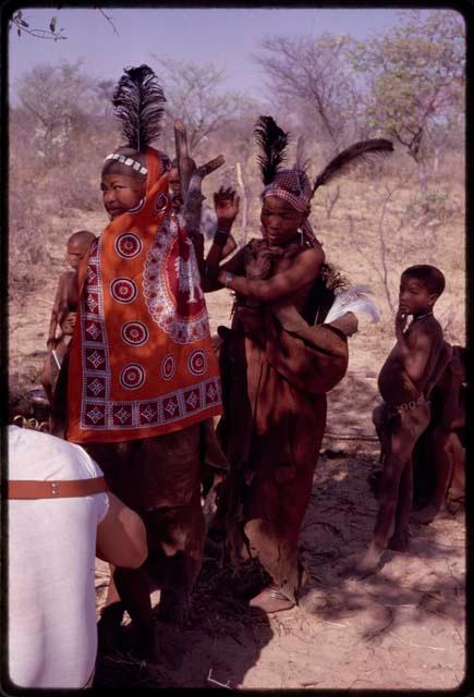 !Ungka and ǂToma's younger wife dancing in praise of a dead ostrich