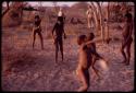 Children playing with a jaqní bird, Lorna Marshall and Wilhelm Camm in the background